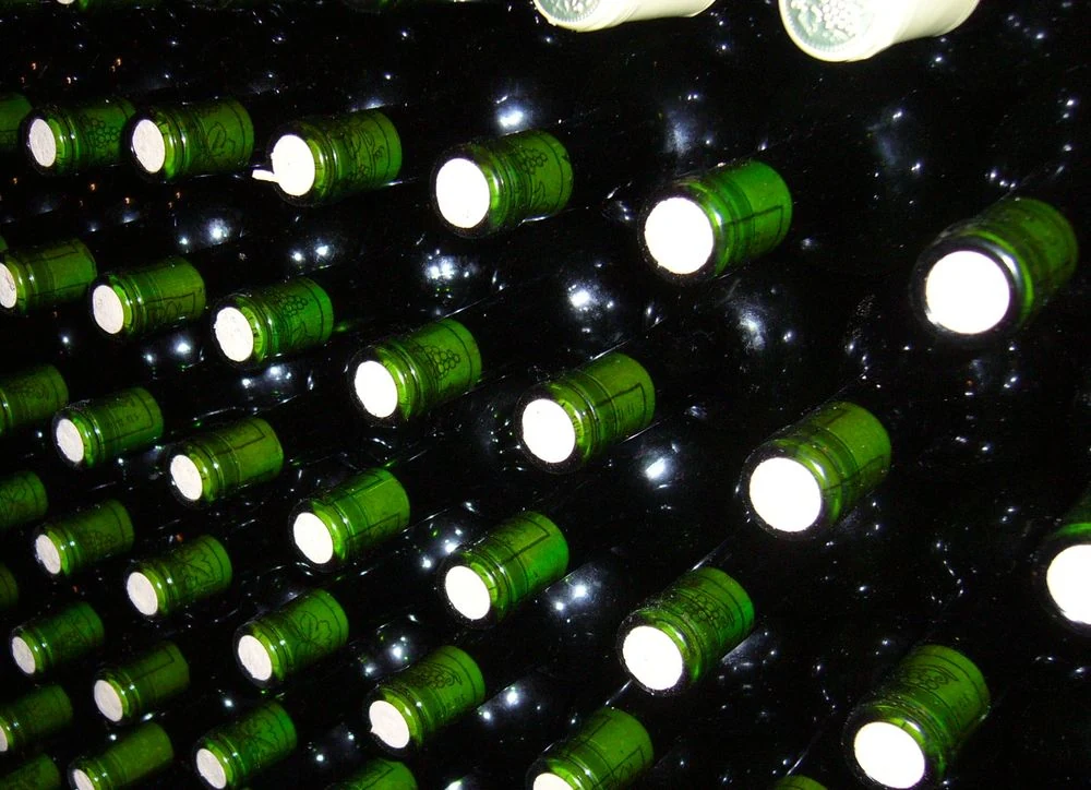 Lahve vína uložené ve vinném sklepě